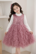 Girl wearing dusty pink sequin tulle dress - studio pastel background
